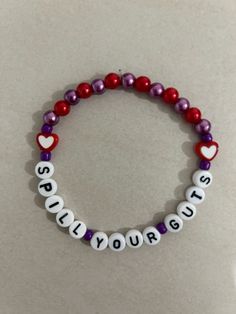 a beaded bracelet with words and hearts on it that says, sorry you're