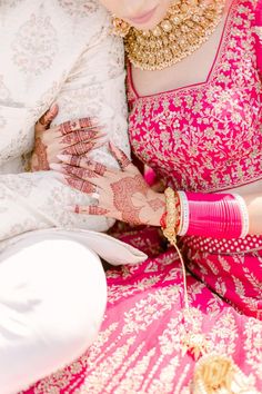 the bride is getting ready to put on her mehnga for her wedding ceremony