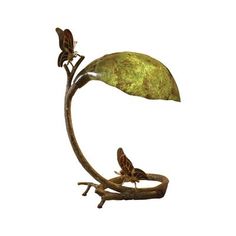 a metal sculpture with two butterflies sitting on it's back legs, and a leaf shaped object in the middle