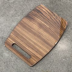 a wooden cutting board sitting on the ground