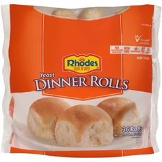 a bag of dinner rolls sitting on top of a white plate