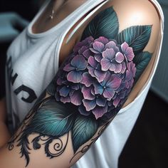 a woman's arm with flowers and leaves on it