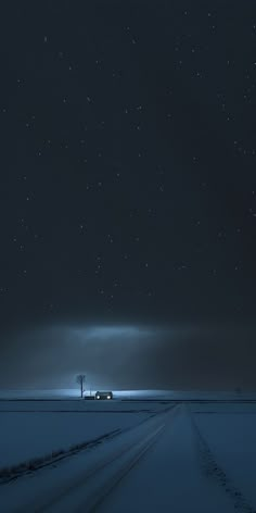 a truck driving down a snow covered road under a night sky with stars above it