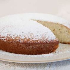 a cake with powdered sugar on it sitting on a plate