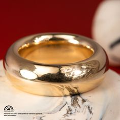 A definite statement piece, this substantial Fairmined Certified gold ring is a stunner. A round profile is comfortable to wear on any finger, and is an interesting idea for a wedding band. Design Specifications: - Type: Ring - Material: SCS recycled yellow gold - Width: 8mm - Thickness: 4mm - Finish: Polished - Profile: Round - high dome