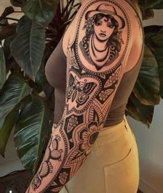 a woman's arm with an intricate tattoo design on the left side of her body