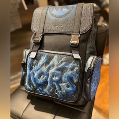 Certainly! Your Customized Men's Michael Kors Cooper Utility Signature Rucksack Backpack Is A True Work Of Art. Imagine A Frozen World Where Style Meets Functionality. This Backpack Boasts A Bold Kors Graphic, Creatively Designed In A Graffiti Frozen Letter Style, Giving The Impression That The Letters Are Sculpted From Shimmering Blue Ice. It's Not Just A Backpack; It's A Statement Piece That Combines Urban Edge With A Touch Of Frosty Elegance. Perfect For Those Who Appreciate The Fusion Of Fas Blue Bag With Adjustable Strap, Designer Michael Kors Backpack With Logo, Designer Backpack With Logo For Everyday Use, Blue Leather Bag For Trip, Designer Logo Backpack For Everyday Use, Blue Travel Bag With Leather Backing, Leather Backpack With Logo For Everyday Use, Designer Leather Backpack With Logo, Rectangular Travel Backpack With Logo