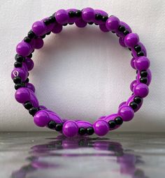 This bracelet is comprised of various shapes of hot purple beads along with various shapes and sizes of shiny black beads.  This pretty bracelet is made with spiraled memory wire so it will fit everyone!  It makes a great gift because you don't have to know someone's wrist size for it to be the perfect fit.    The matching earrings in picture #6 can be found at this link: https://www.etsy.com/listing/1109337928/earrings-hot-purple-and-black-dangle The matching necklace in picture #7  is here: ht Cheap Purple Jewelry With Black Beads, Purple Beaded Bracelets With Black Beads As A Gift, Adjustable Purple Bracelet With Black Beads, Adjustable Purple Bracelets With Black Beads, Adjustable Purple Bangle Bracelet, Adjustable Purple Bangle Stretch Bracelet, Adjustable Purple Stretch Bangle Bracelet, Gray Bracelet, Purple Beads