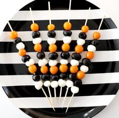 black and white striped plate with skewered candy