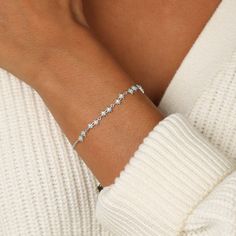 Add a little sparkle to your everyday style with this bracelet. Star-shaped charms are adorned with clear crystals that catch the light. The chain is finished with a lobster clasp for a secure and comfortable fit. Get it as a gift for any starry-eyed romantic or just as a treasured addition to your own collection. Star Jewelry With Lobster Clasp, Dainty Star Charm Bracelet, Glowing Crystal, Bracelet Star, Snowflake Bracelet, Starry Eyed, Wardrobe Planning, White Crystals, Crystal Chain