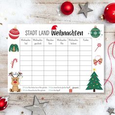 a printable christmas planner with ornaments and decorations around it on top of a wooden table