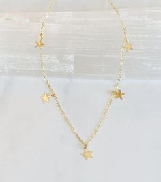 This sweet little necklace would make the perfect gift. Five tiny little 14kt gold filled stars dangle from the 14kt gold filled fine cable chain.    Each star is hammered with a dappled texture to catch the light beautifully.  The length of the chain is 16.5” and is finished with a spring ring clasp and my signature large end ring. Nickel-free 14k Gold-filled Gold Threader Earrings, Gold 14k Gold-filled Threader Earrings With Adjustable Chain, Handmade Minimalist 14k Gold Filled Threader Earrings, 14k Yellow Gold Filled Threader Earrings With Delicate Chain, Delicate 14k Yellow Gold Filled Threader Earrings, Minimalist Gold Threader Earrings With Adjustable Chain, Dainty 14k Gold Threader Earrings With Adjustable Chain, Dainty 14k Gold Threader Earrings With Delicate Chain, 14k Gold Filled Threader Earrings For Everyday