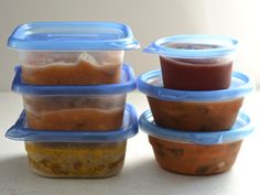 four plastic containers with food in them stacked on top of each other