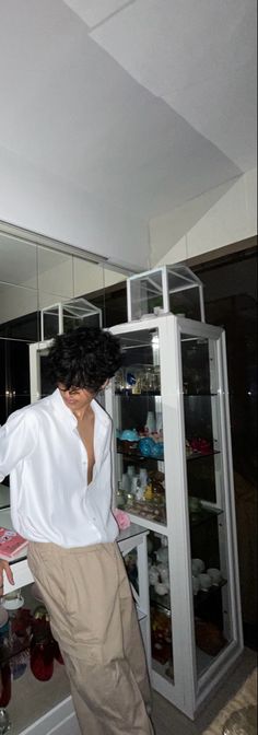 a man standing in front of a refrigerator freezer