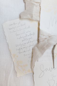 the wedding stationery is laid out on top of each other