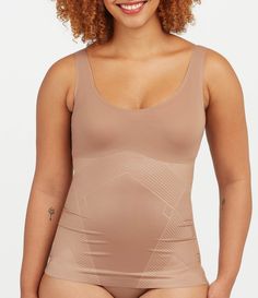 From Spanx&#x2C; this tank features:Lightweight&#x2C; single-layer tummy shaping Flat neckline & armhole stay invisible under clothes Fit-flexible hem construction Body: Nylon/Lycra® elastane; bust: nylon/elastaneMachine wash cold/gentle cycle/do not use fabric softener/only non-chlorine bleach when needed/tumble dry low/do not ironImported. Compression Shapewear With Built-in Bra In Elastane, Compression Scoop Neck Top With Built-in Bra, High Stretch Nylon Tank Top With Built-in Bra, Compression Shapewear With Built-in Bra, Compression Shapewear With Built-in Bra Sleeveless, High Stretch Smoothing Sleeveless Shapewear, Compression Sleeveless Shapewear With Built-in Bra, Sleeveless High Stretch Smoothing Shapewear, Workout Shapewear Tank Top With Built-in Bra