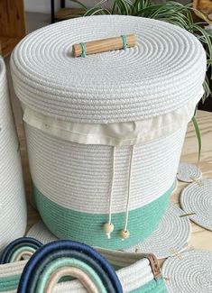 two large baskets sitting on top of a table next to rugs and potted plants