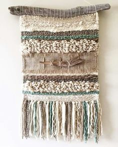 a wall hanging made out of yarn and wood