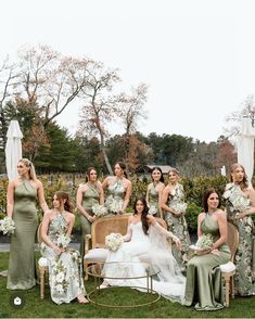 a group of bridesmaids pose for a photo in front of an outdoor setting