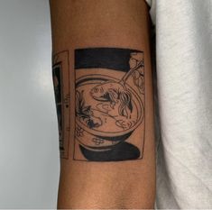 a person with a tattoo on their arm has a fish bowl in front of him