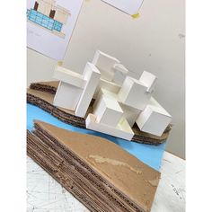 several pieces of cardboard stacked on top of each other in front of a drawing board