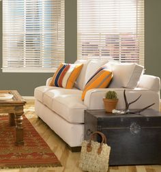 a living room filled with furniture and a wooden coffee table in front of a window