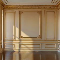 an empty room with wooden floors and gold trim on the walls, along with white paneling