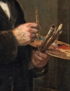 a man holding paintbrushes and an easel in his hands