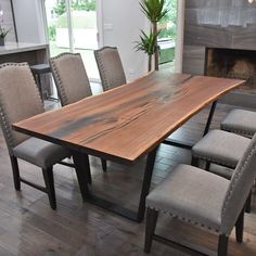 a large wooden table surrounded by grey chairs