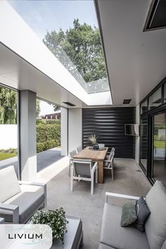 an open living room and dining area with sliding glass doors