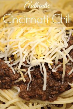 a close up of a plate of food with spaghetti and cheese on top, the words authentic cincinnati chili above it