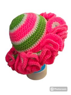 a crocheted hat with pink, green and white stripes