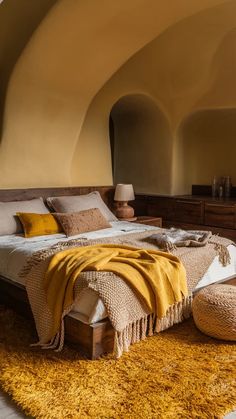 a large bed sitting in a bedroom on top of a yellow rug