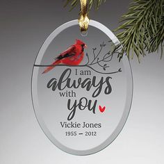 a glass ornament with a cardinal on it and the words i am always with you