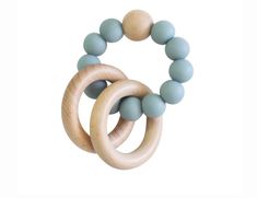 two wooden rings with light blue beads on each one and an unfinished wood bead in the middle