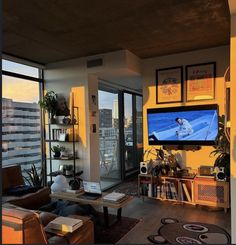 a living room filled with furniture and a flat screen tv mounted to the side of a wall