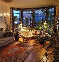 a living room filled with furniture and lots of plants on top of it's windowsill