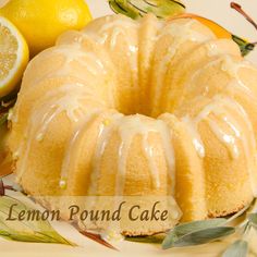 a lemon bunt cake with icing on a plate next to sliced lemons