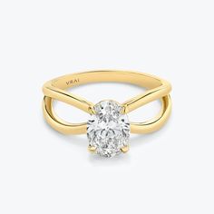 a yellow gold engagement ring with an oval cut diamond in the center, on a white background