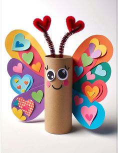 a toilet paper roll decorated with hearts and a butterfly