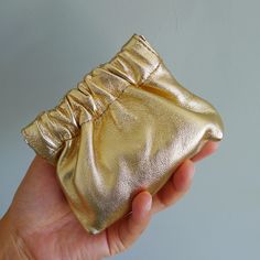 This shinning mini gold coin purse may look small, but its capacity is anything but. Combining an elegant, luxurious appearance with practical functionality, it's the perfect companion for your daily life. Crafted from soft lambskin leather with a silky smooth touch, it surprises with its unexpectedly large capacity, easily holding your coins, cards, keys, and other small essentials. We hope this stylish coin purse adds a touch of refined brilliance to your everyday life. ❤100% Handmade in UK ❤M Luxury Pouch Coin Purse For Daily Use, Gold Wallets With Removable Pouch, Gold Rectangular Wallets With Removable Pouch, Gold Wallet With Removable Pouch, Gold Rectangular Wallet With Removable Pouch, Elegant Gold Wallet With Coin Pocket, Gold Rectangular Wallets For Personal Use, Gold Rectangular Wallet For Personal Use, Compact Gold Wallet For Everyday Use