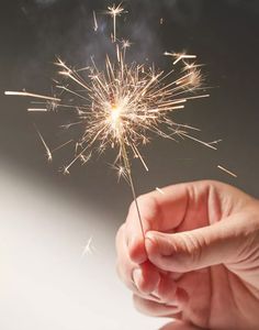 a person holding a sparkler in their hand