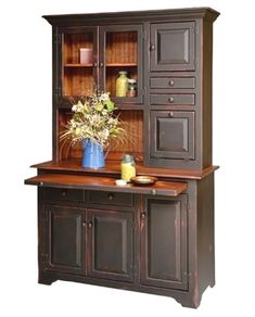 a wooden hutch with flowers and candles on it's sideboard, against a white background