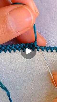 someone is stitching the end of a piece of fabric