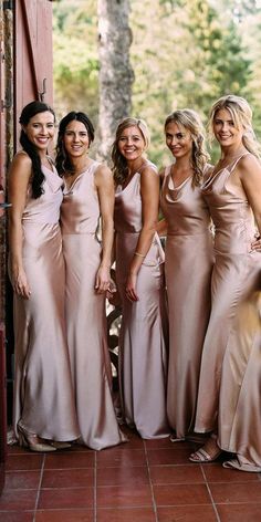 the bride and her bridesmaids pose for a photo