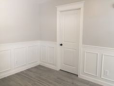 an empty room with white walls and wood flooring is pictured in this image, there are two doors on either side of the door