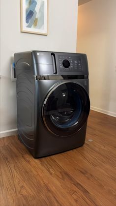 a washing machine sitting on top of a hard wood floor