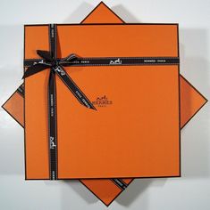 an orange card with black ribbon and bow