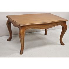 an old wooden table sitting on top of a white floor