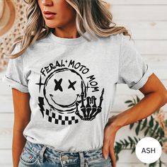 Motocross Shirt, Motocross Mama Race T-Shirt, Race Day Tee, Race Day Vibes, Race Season, Gifts for Racing, Motocross Shirt, Sports Mom 🖤 Processing time 3-10 business days (excludes the weekend) 🖤 SHIPPING INFO 3-5 business days (excludes the weekend)  It is that time of year where shipping delays across all carriers are at an all time high. We urge customers to please plan for the full production time frame and plan for shipping to take long then usual. First Class shipping DOES NOT include i White Biker Top With Letter Print, Letter Print Crew Neck Tops For Biker Events, White Moto T-shirt For Streetwear, White Moto Style T-shirt For Streetwear, Casual Custom Print Tops For Biker Events, Moto Style Cotton Top With Graphic Print, Moto Crew Neck Tops With Graphic Print, Moto Style Graphic Print Crew Neck T-shirt, White Moto Crew Neck T-shirt